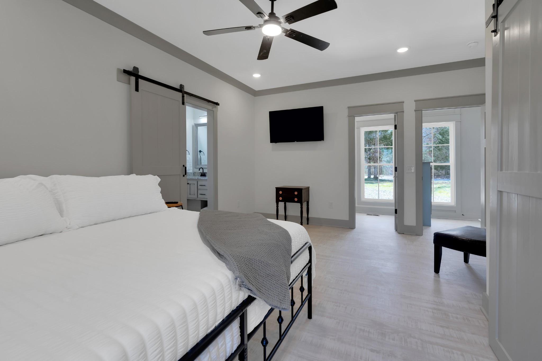 591 Ghea Road Normandy, TN 37360 - Photo 35 of 48 a spacious bedroom with a bed a table and a flat screen tv