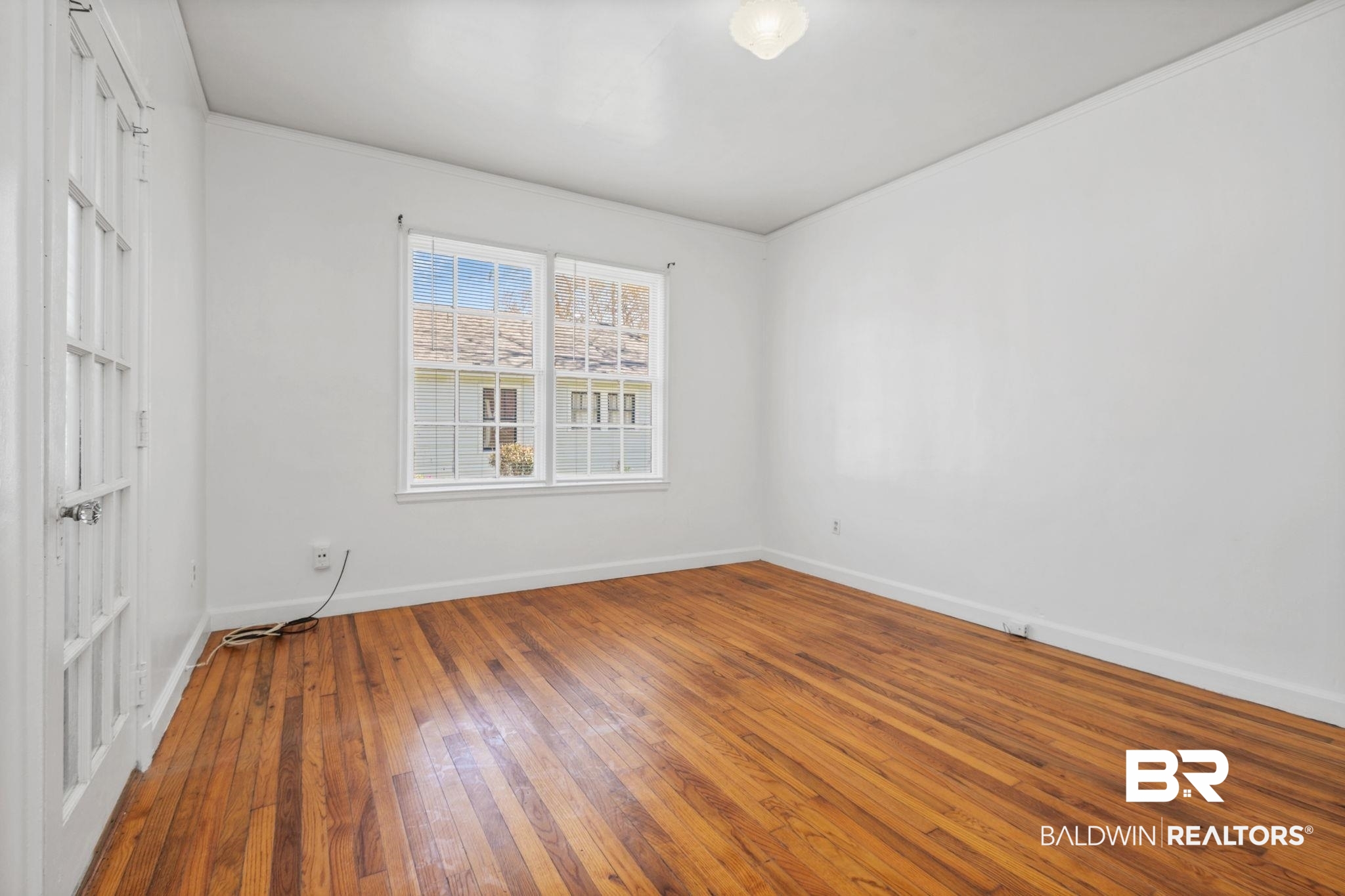 1707 Church Street Mobile, AL 36604 - Photo 12 of 43 Unfurnished bedroom with baseboards and wood-type flooring