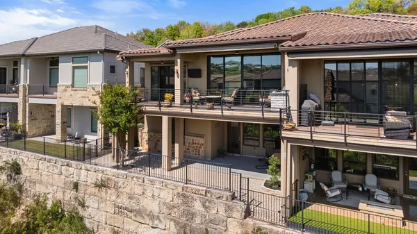 a view of a house with backyard porch and sitting area