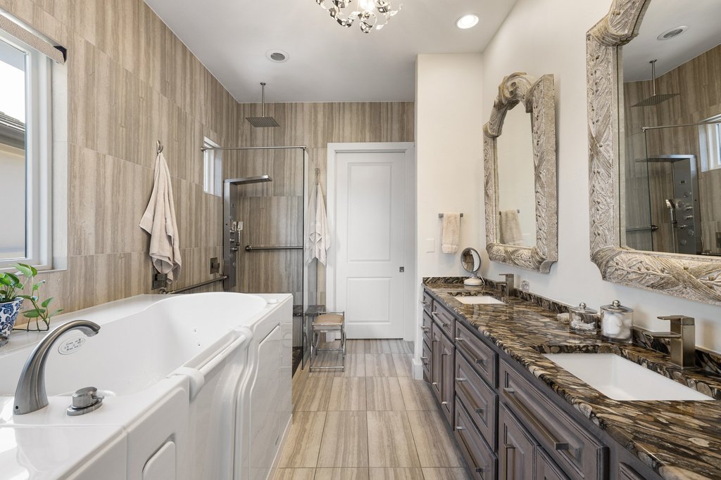 212 Marina View Way, Unit 11A Lakeway, TX 78734 - Photo 13 of 19 a bathroom with a granite countertop double vanity sink a mirror and a shower