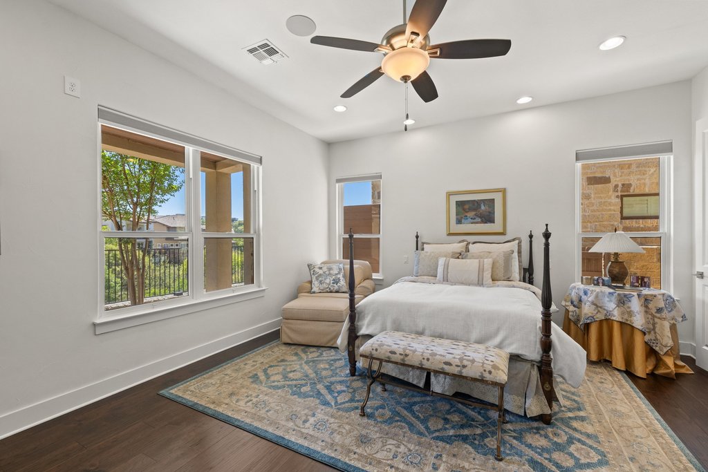212 Marina View Way, Unit 11A Lakeway, TX 78734 - Photo 16 of 19 a bedroom with a large bed and a window