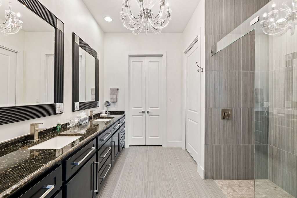 212 Marina View Way, Unit 11A Lakeway, TX 78734 - Photo 17 of 19 a bathroom with a granite countertop sink a large mirror and a shower
