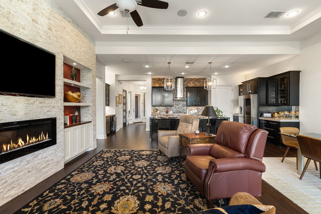212 Marina View Way, Unit 11A Lakeway, TX 78734 - Photo 6 of 19 a living room with furniture a flat screen tv and a fireplace