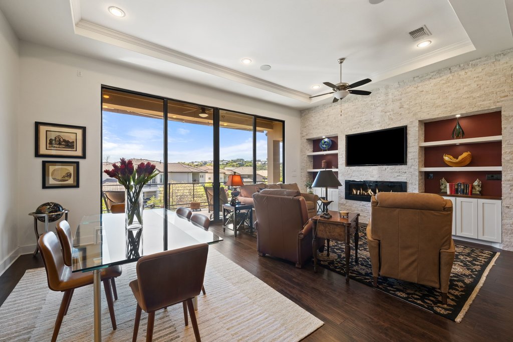 212 Marina View Way, Unit 11A Lakeway, TX 78734 - Photo 7 of 19 a living room with fireplace furniture and a flat screen tv