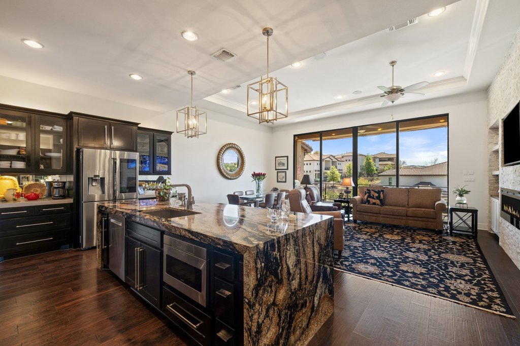 212 Marina View Way, Unit 11A Lakeway, TX 78734 - Photo 9 of 19 a kitchen with stainless steel appliances granite countertop a stove and a view of living room