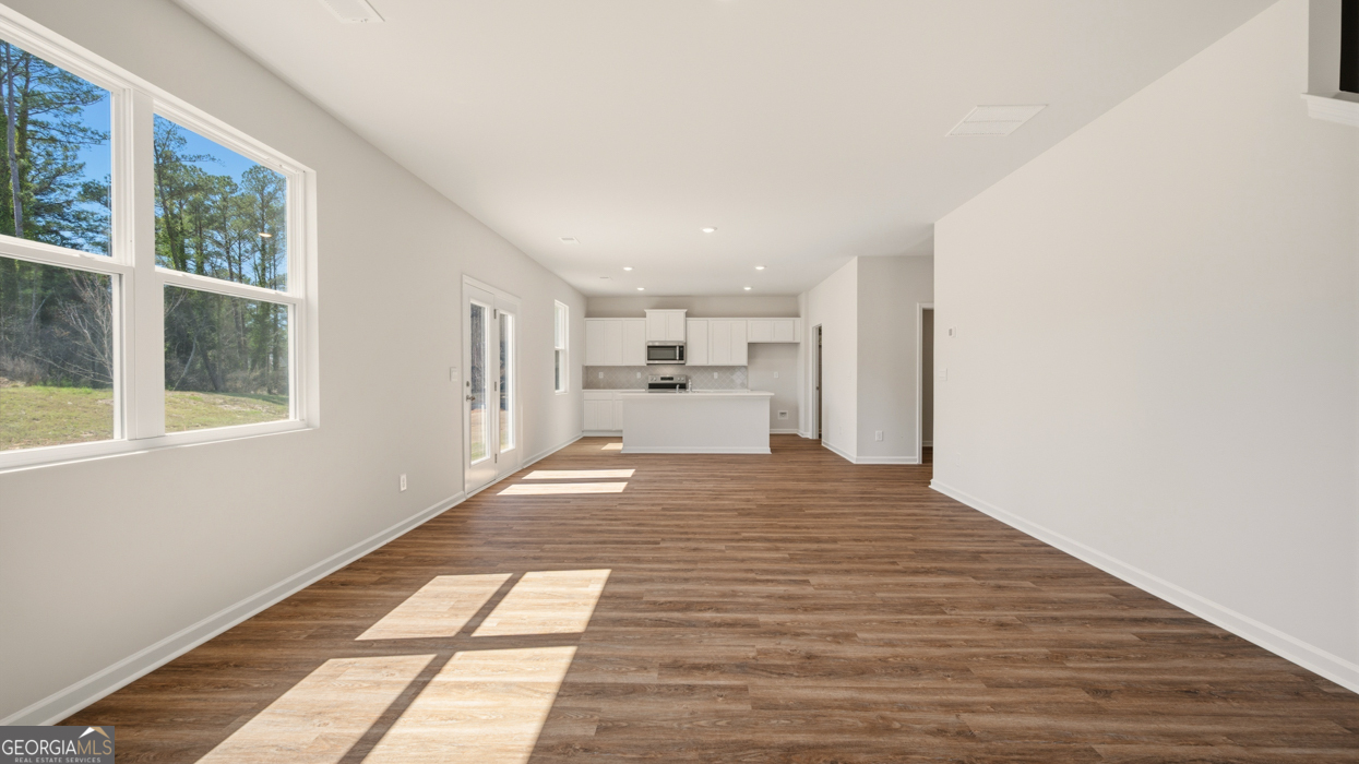 8578 Seabiscuit Road Lithonia, GA 30058 - Photo 15 of 30 a view of a kitchen with wooden floor electronic appliances and windows
