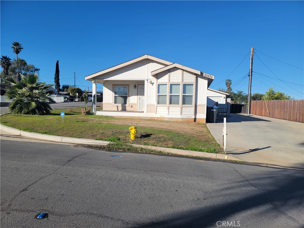 20230 Planada Court Riverside, CA 92508 - Photo 1 of 9 a view of a house with a yard and sitting area