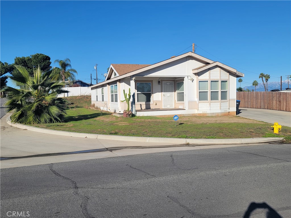 20230 Planada Court Riverside, CA 92508 - Photo 2 of 9 a front view of a house with a yard and garage