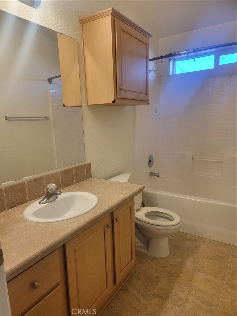 20230 Planada Court Riverside, CA 92508 - Photo 8 of 9 a bathroom with a sink a toilet and mirror