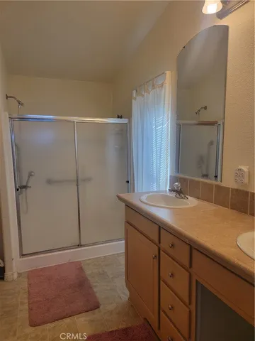 a bathroom with a granite countertop sink and mirror