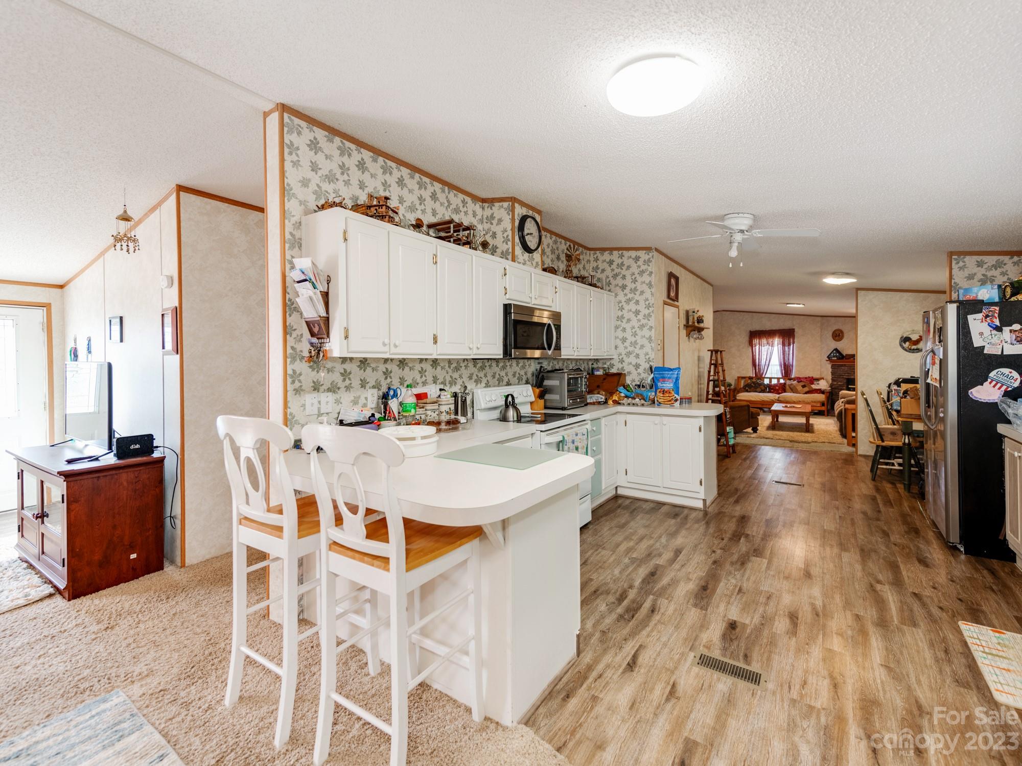 1168 Hopps Road Chester, SC 29706 - Photo 11 of 32 a living room with stainless steel appliances kitchen island granite countertop a sink and wooden floor