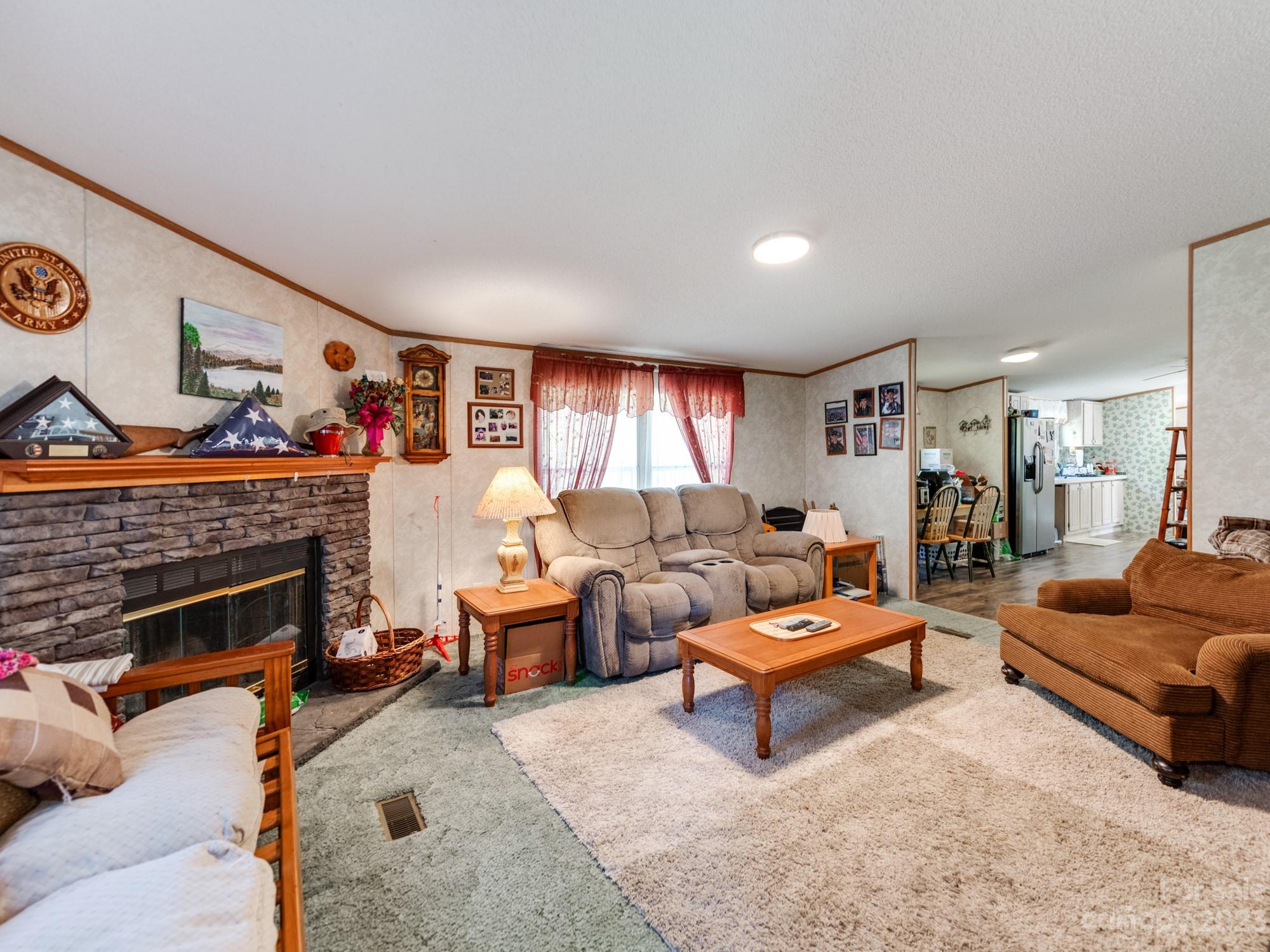 1168 Hopps Road Chester, SC 29706 - Photo 18 of 32 a living room with furniture a fireplace and a flat screen tv