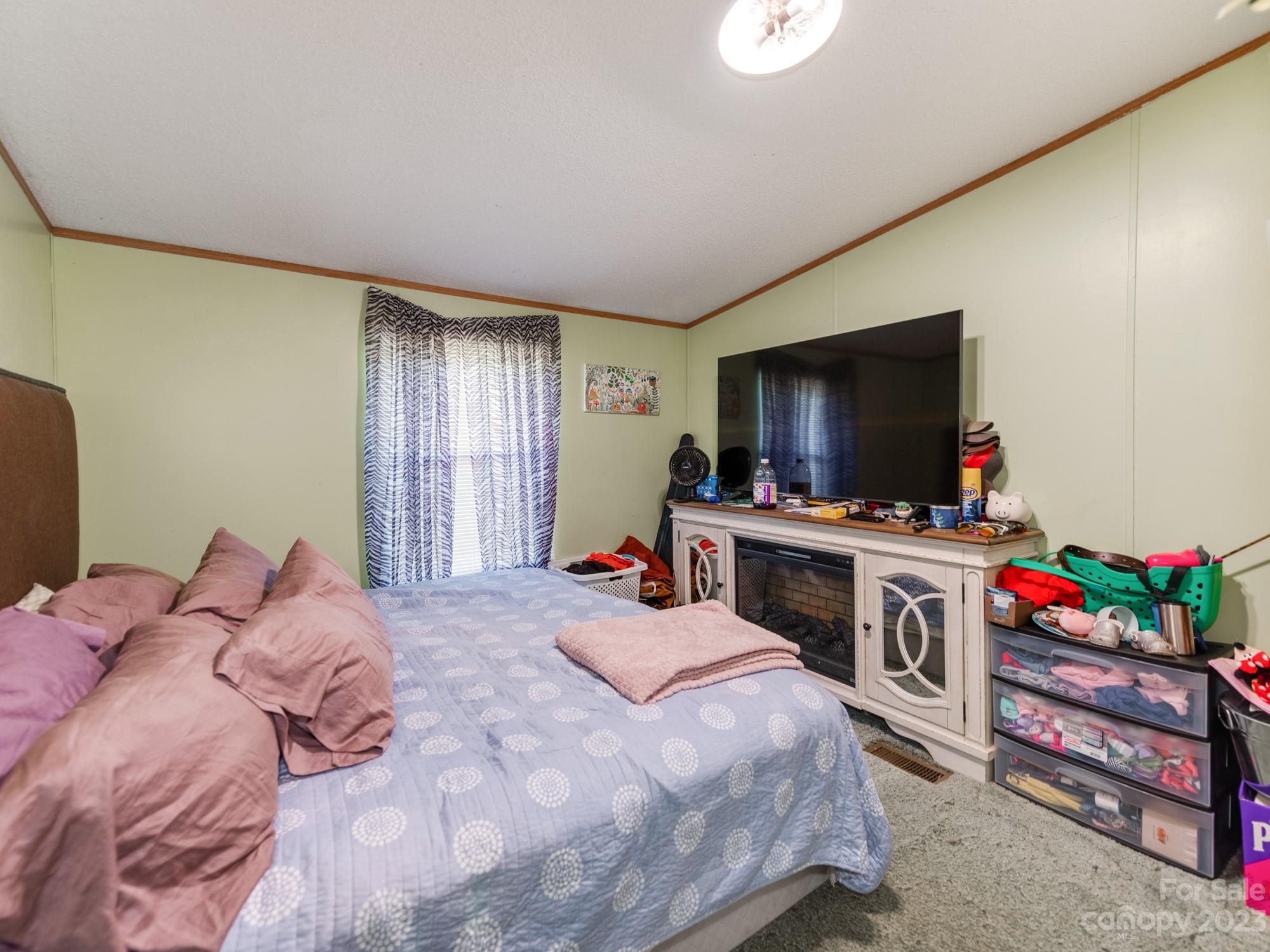 1168 Hopps Road Chester, SC 29706 - Photo 22 of 32 a bedroom with a bed and a flat screen tv
