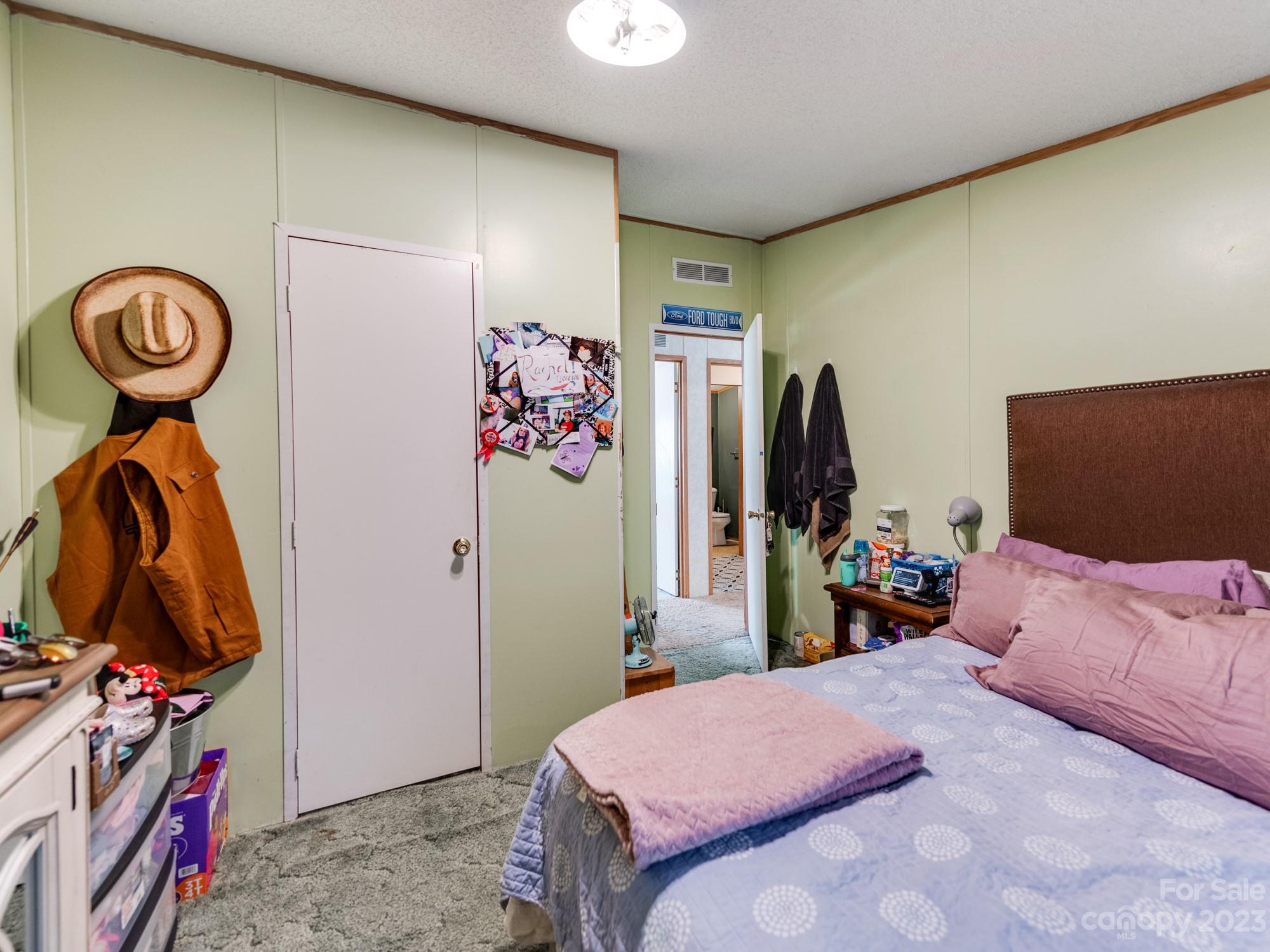 1168 Hopps Road Chester, SC 29706 - Photo 23 of 32 a bedroom with a bed and a flat tv screen on the dresser