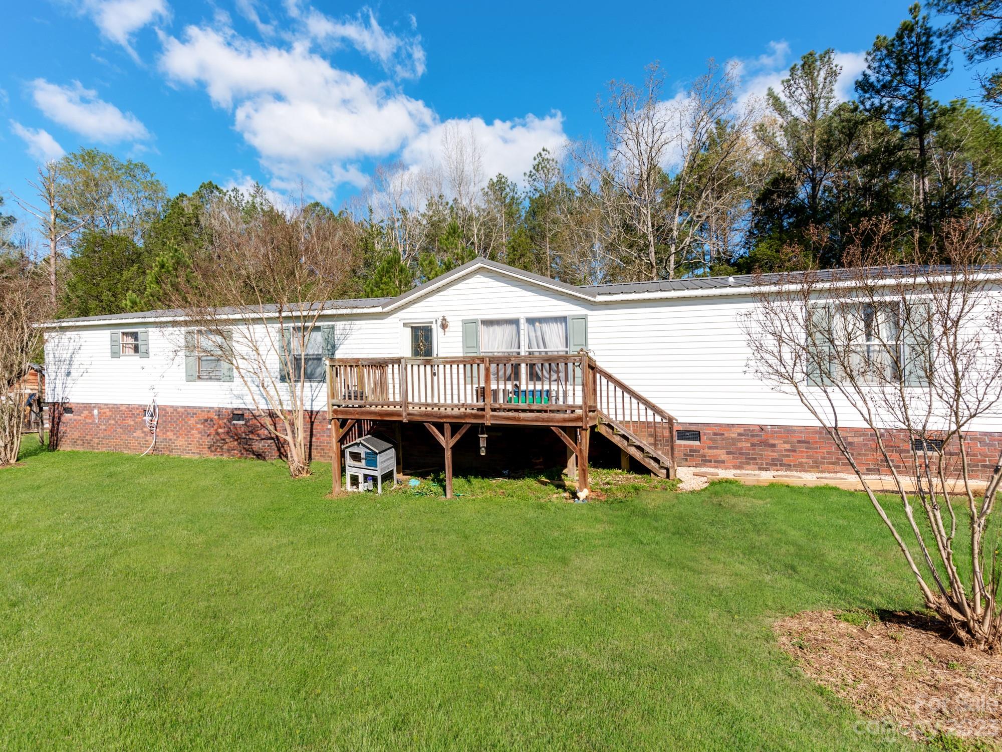 1168 Hopps Road Chester, SC 29706 - Photo 3 of 32 a view of a house with a big yard and large trees