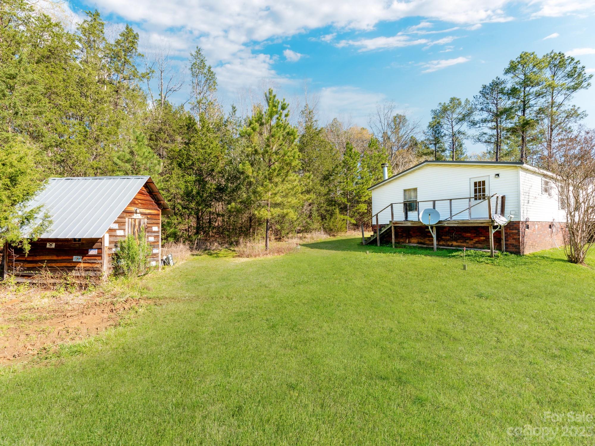 1168 Hopps Road Chester, SC 29706 - Photo 31 of 32 a view of a house with a big yard and large trees