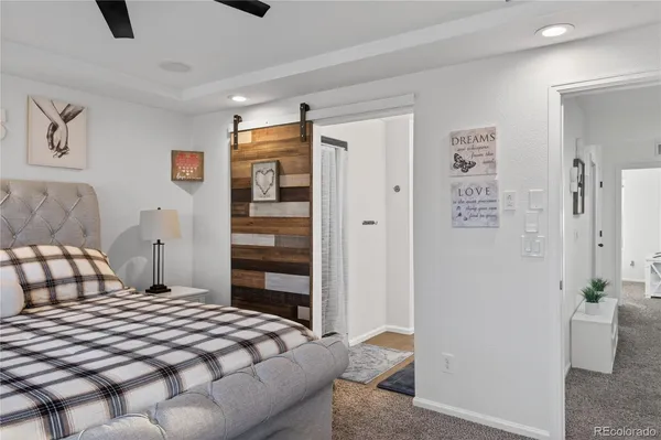 a bedroom with a bed and flat screen tv