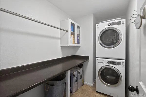 a bathroom with a granite countertop sink a toilet and a mirror