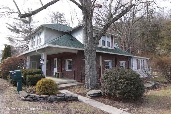 a front view of a house with a garden