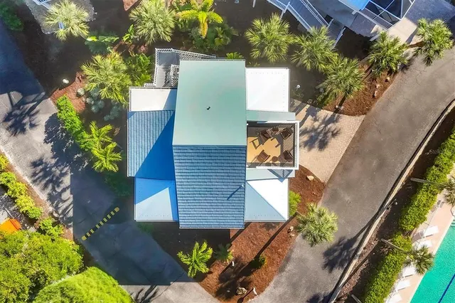 a front view of a house with a yard and potted plants