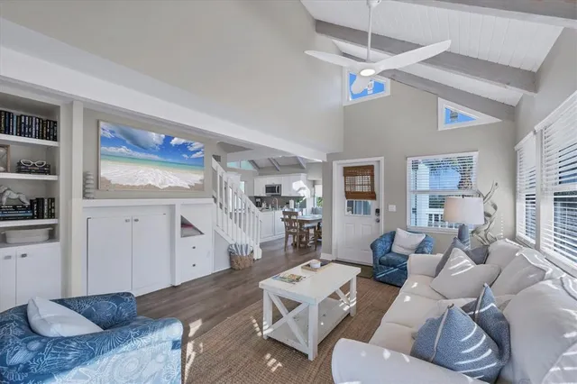 a kitchen with a table chairs microwave and cabinets