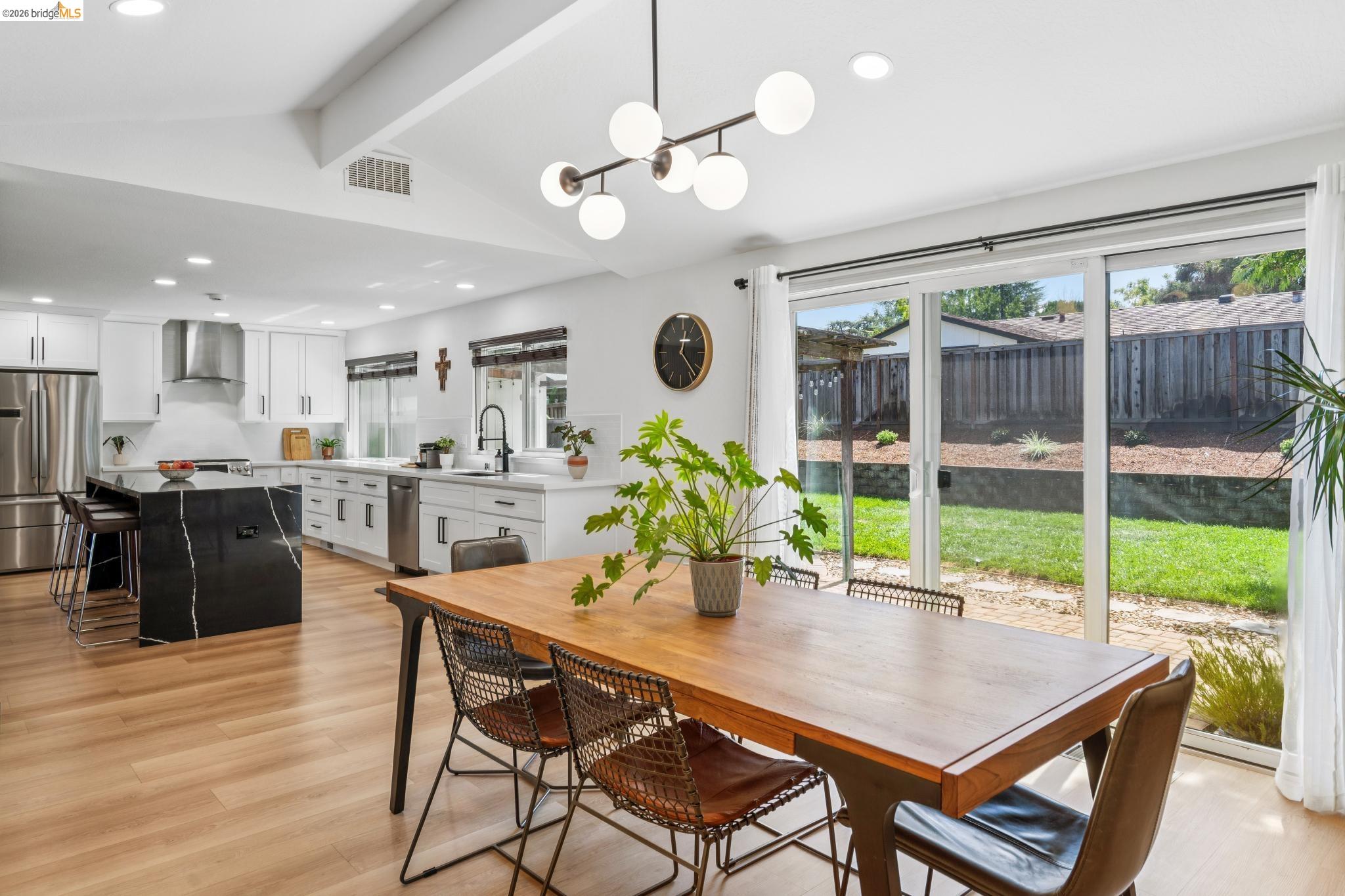 Dining area with recessed lighting, light wood-type flooring, and a chandelier