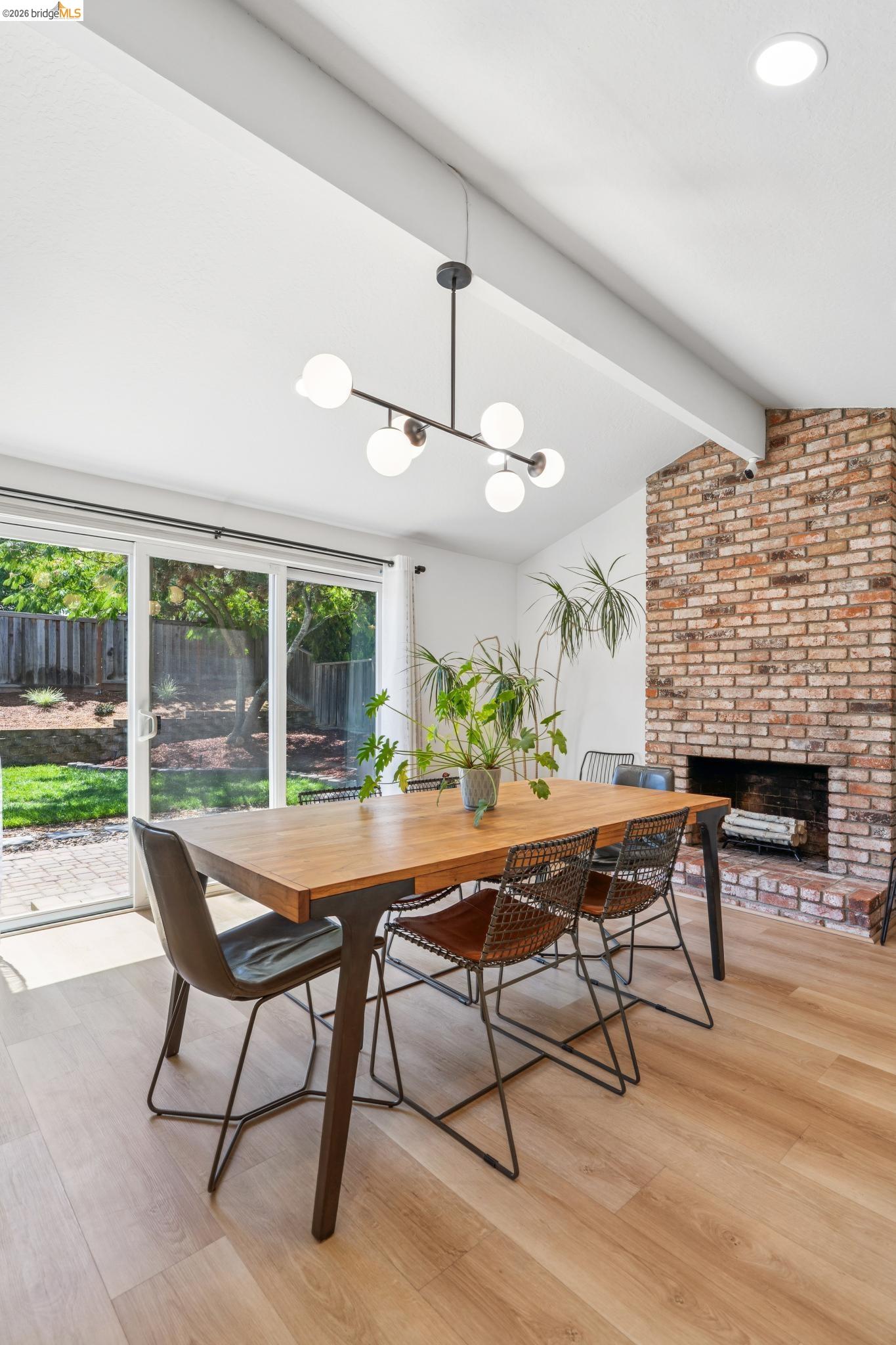 3093 Diablo View Road Pleasant Hill, CA 94523 - Photo 15 of 43 Dining room featuring a brick fireplace, light wood-style flooring, and a chandelier