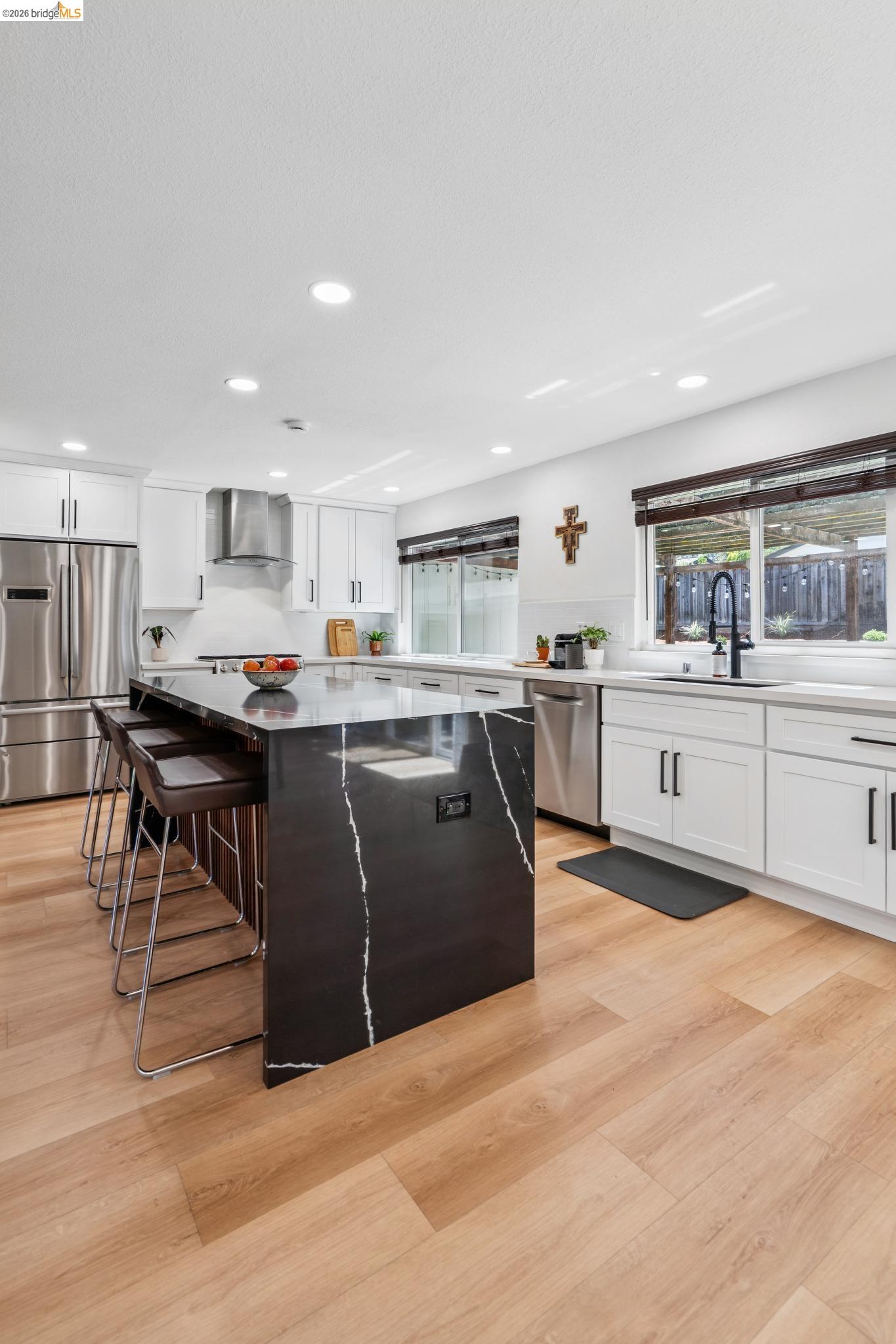3093 Diablo View Road Pleasant Hill, CA 94523 - Photo 15 of 43 Kitchen featuring white cabinetry, a kitchen island, light stone countertops, appliances with stainless steel finishes, and recessed lighting