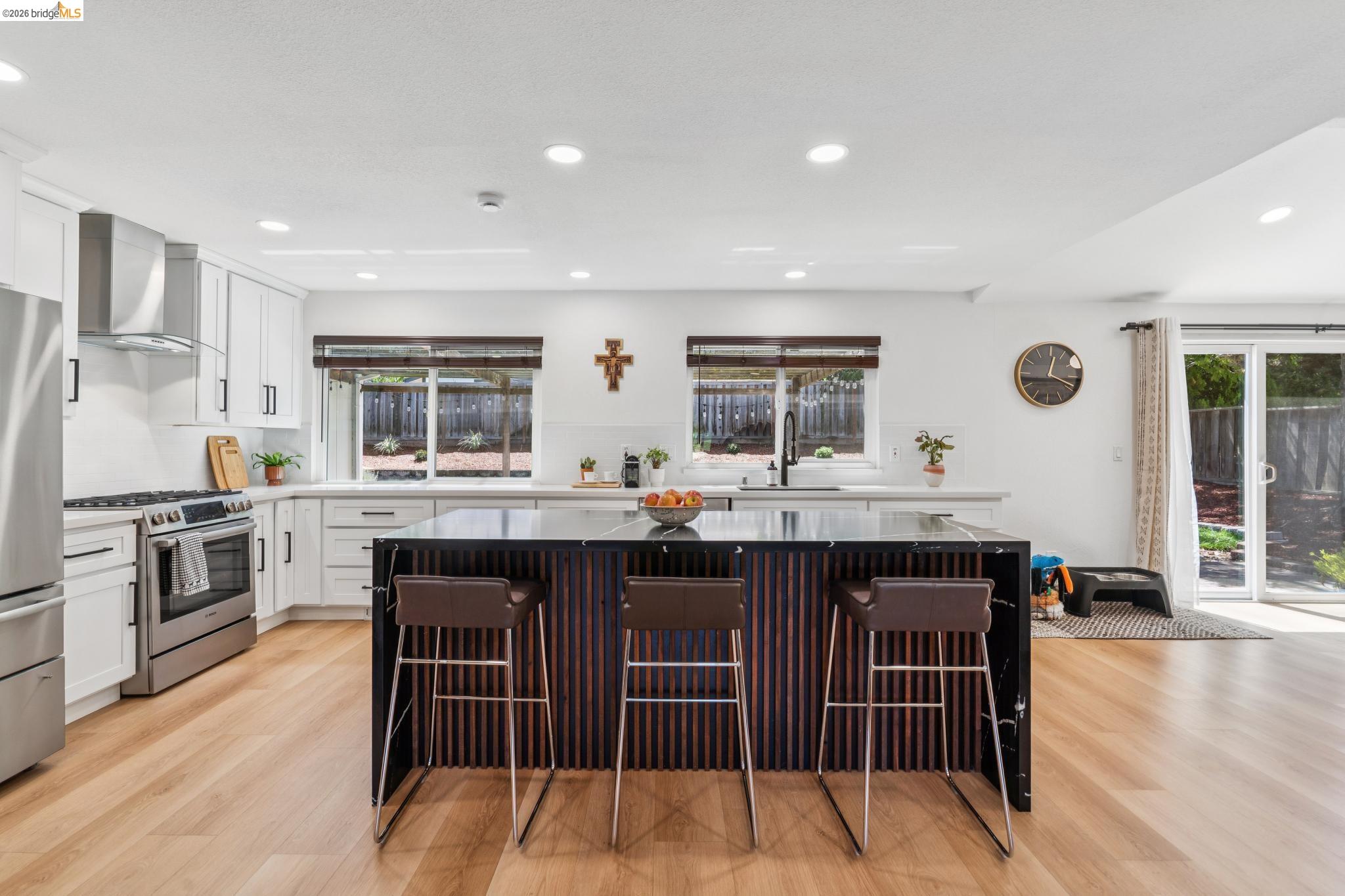 3093 Diablo View Road Pleasant Hill, CA 94523 - Photo 28 of 43 Kitchen with a center island, light wood-type flooring, a breakfast bar, appliances with stainless steel finishes, and recessed lighting