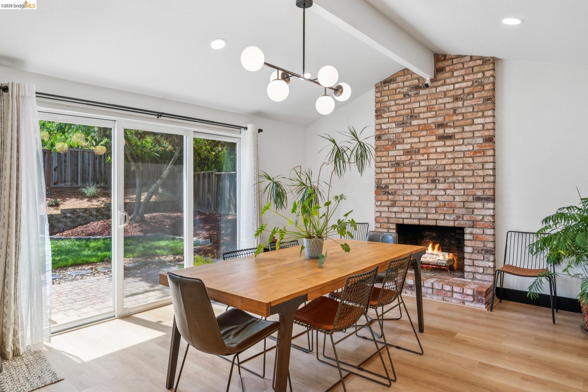 3093 Diablo View Road Pleasant Hill, CA 94523 - Photo 8 of 43 Dining area featuring a fireplace, light wood finished floors, recessed lighting, and a chandelier