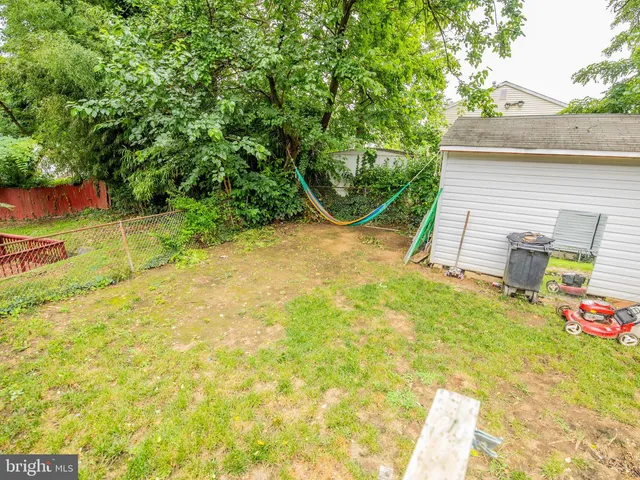 a view of a backyard with plants and a patio