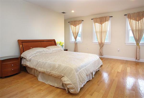 1593 Centre Street Boston, MA 02132 - Photo 6 of 7 a large bed sitting in a bedroom next to a window