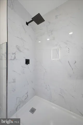 a bathroom with a bathtub and shower