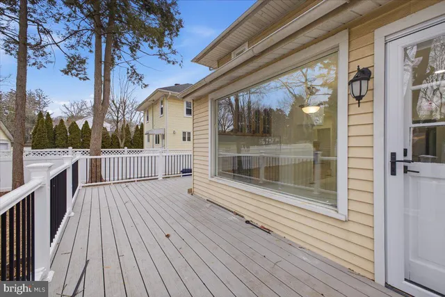 a balcony with wooden floor and door