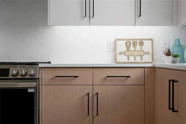 a kitchen with a refrigerator and a stove