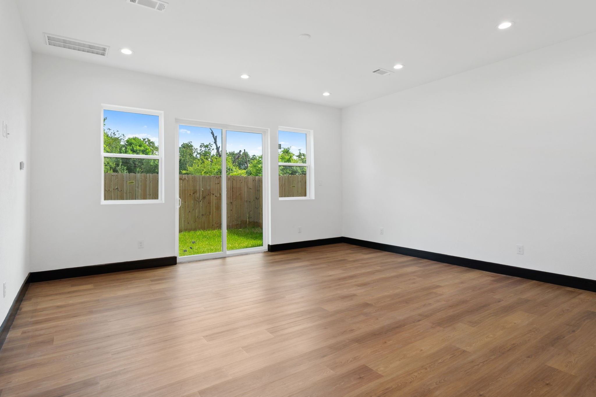 4437 Gunter Street, Unit AB Houston, TX 77020 - Photo 5 of 20 a view of an empty room with wooden floor and a window