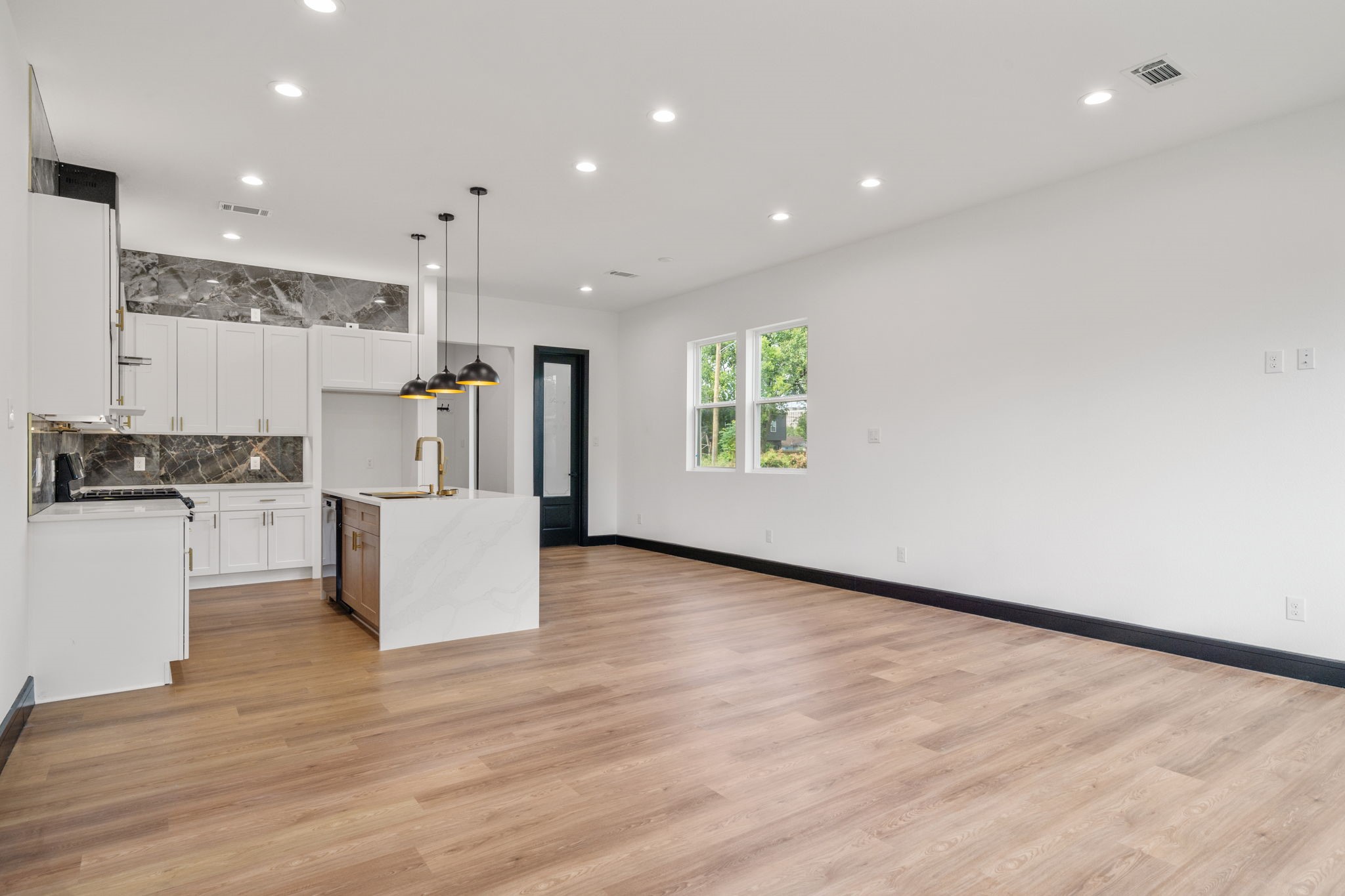 4437 Gunter Street, Unit AB Houston, TX 77020 - Photo 6 of 20 a view of kitchen with cabinets and wooden floor