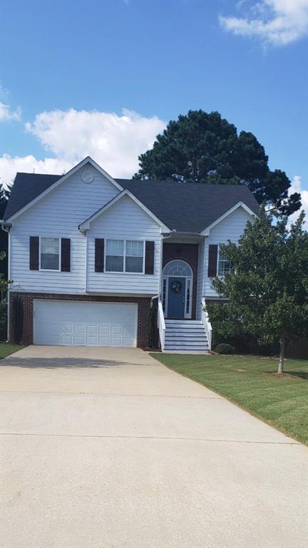 3475 Mist Court Villa Rica, GA 30180 - Photo 1 of 1 a front view of a house with a garden and yard