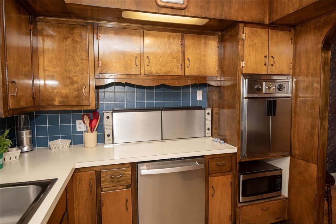 706 Stones Crossing Road Easton, PA 18045 - Photo 11 of 40 A well-appointed kitchen features rich wood cabinetry and essential appliances for modern living. Notice the cook top stove is hidden for more counter space