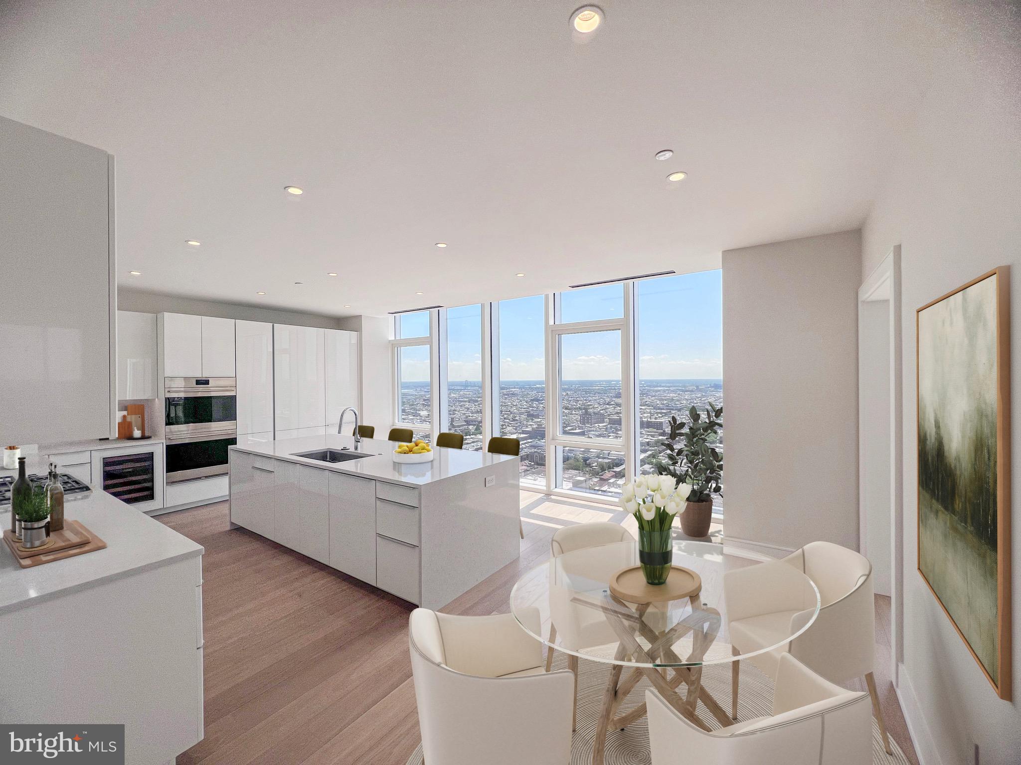 301 South Broad Street, Unit 3602 Philadelphia, PA 19107 - Photo 3 of 17 a living room with stainless steel appliances kitchen island granite countertop a table chairs and a refrigerator