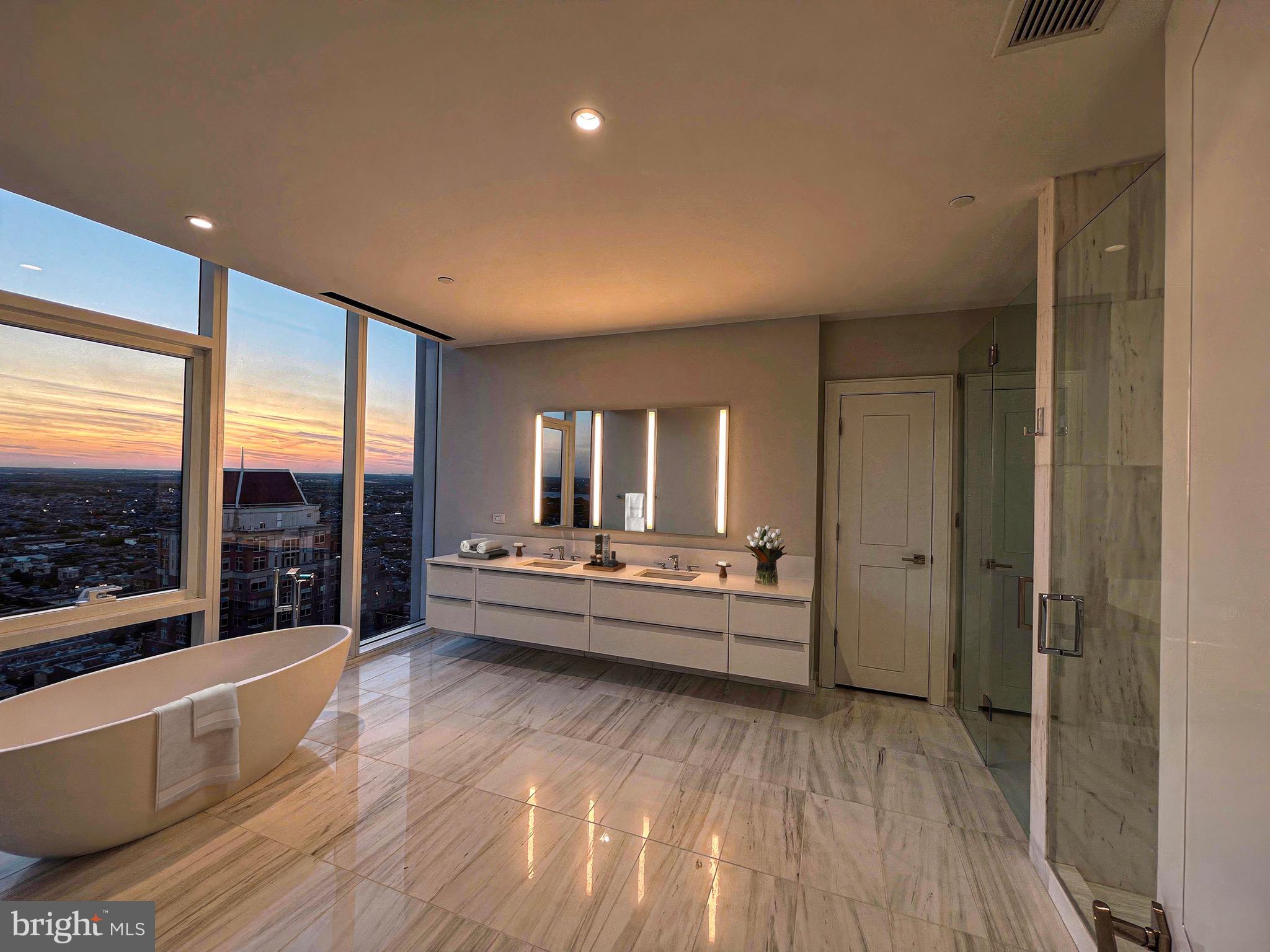 301 South Broad Street, Unit 3602 Philadelphia, PA 19107 - Photo 5 of 17 a large white room with a large window and sitting area