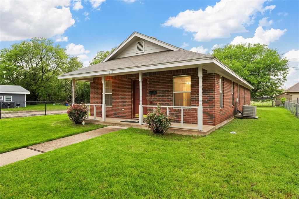 Ranch-style house featuring brick siding, covered porch, central AC unit, and roof with shingles