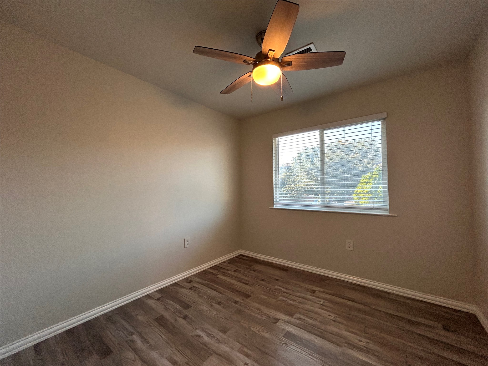 8920 Trone Circle, Unit B Austin, TX 78758 - Photo 13 of 19 an empty room with wooden floor and windows