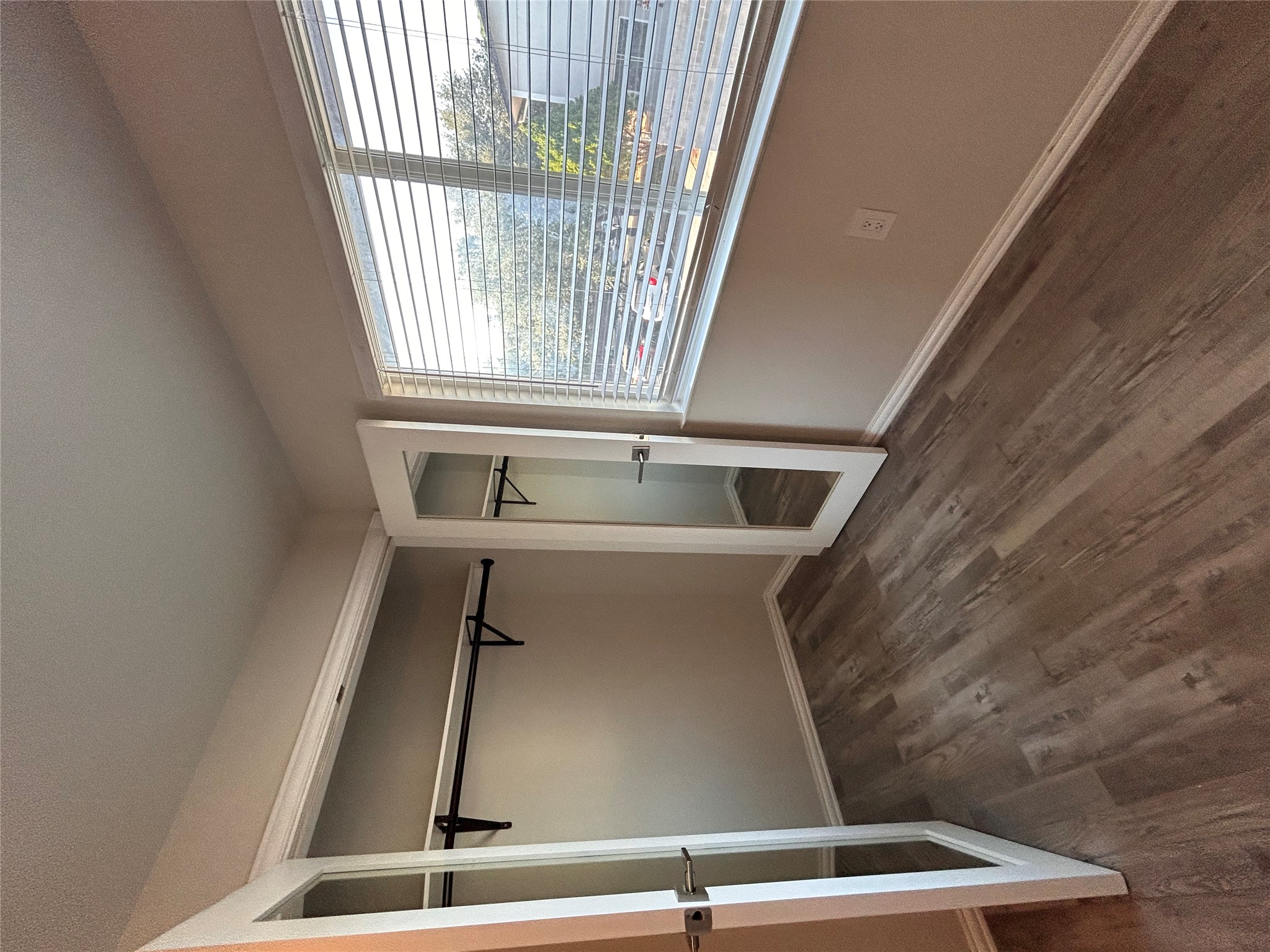 8920 Trone Circle, Unit B Austin, TX 78758 - Photo 16 of 19 a view of an empty room with wooden floor and a window