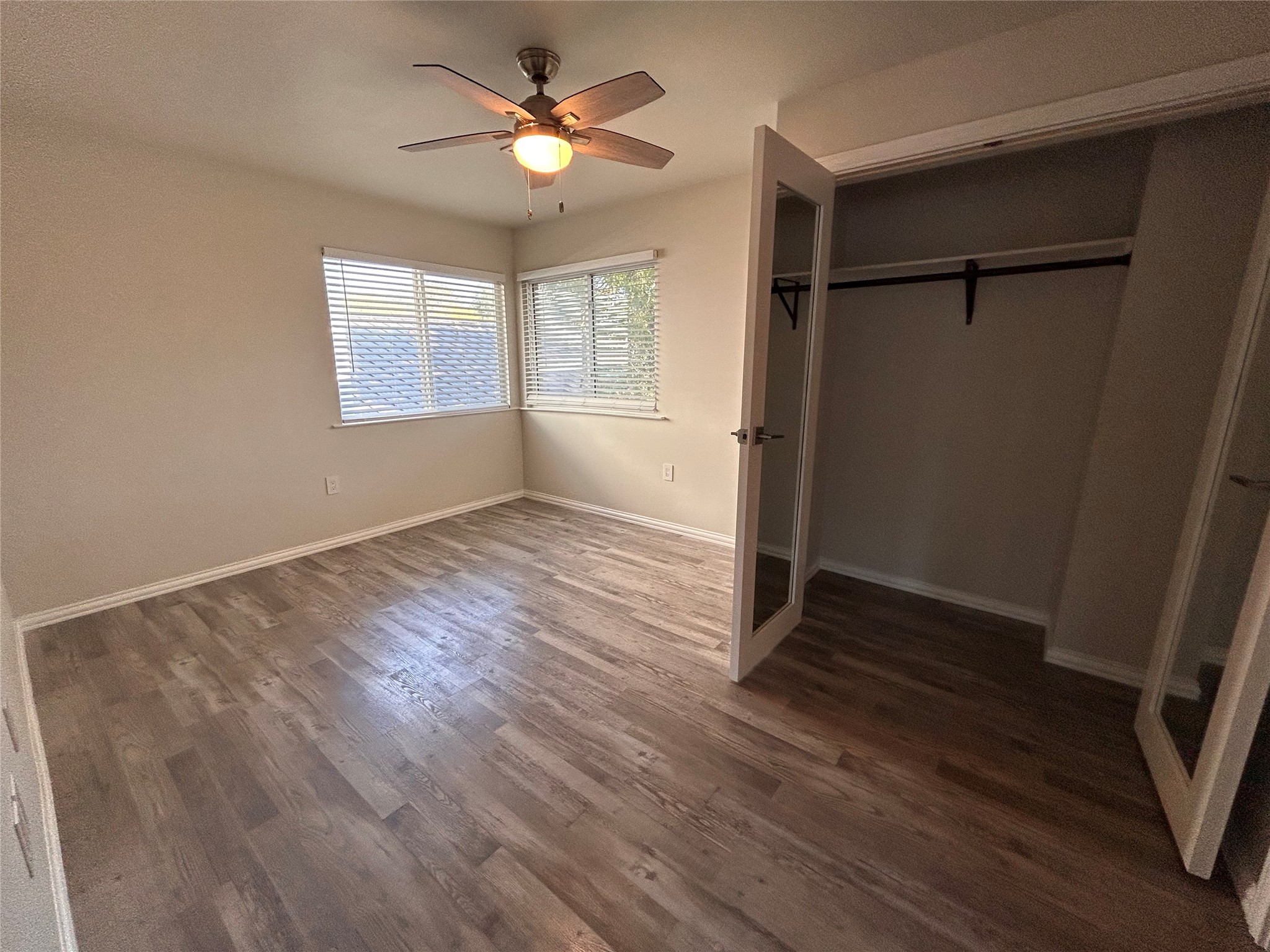 8920 Trone Circle, Unit B Austin, TX 78758 - Photo 17 of 19 wooden floor in an empty room with a window