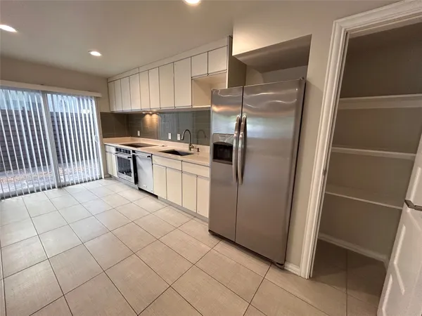 a kitchen with stainless steel appliances a sink stove and cabinets