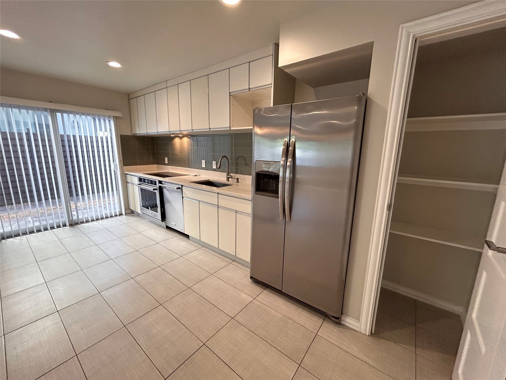 8920 Trone Circle, Unit B Austin, TX 78758 - Photo 5 of 19 a kitchen with stainless steel appliances granite countertop a refrigerator and a sink