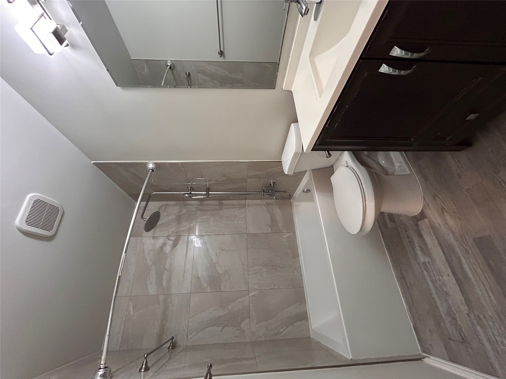 8920 Trone Circle, Unit B Austin, TX 78758 - Photo 10 of 19 a bathroom with a sink a toilet a mirror and bathtub