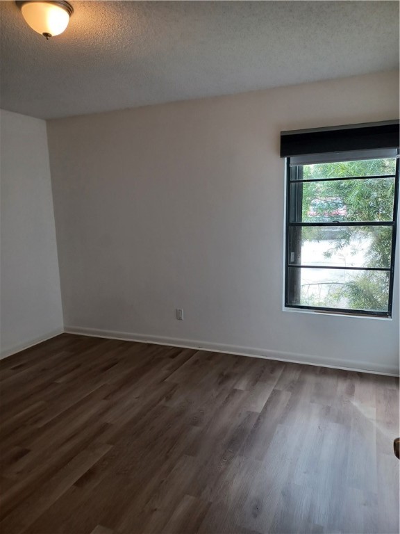 Undisclosed Address Vero Beach, FL 32960 - Photo 13 of 18 a view of an empty room with wooden floor and a window