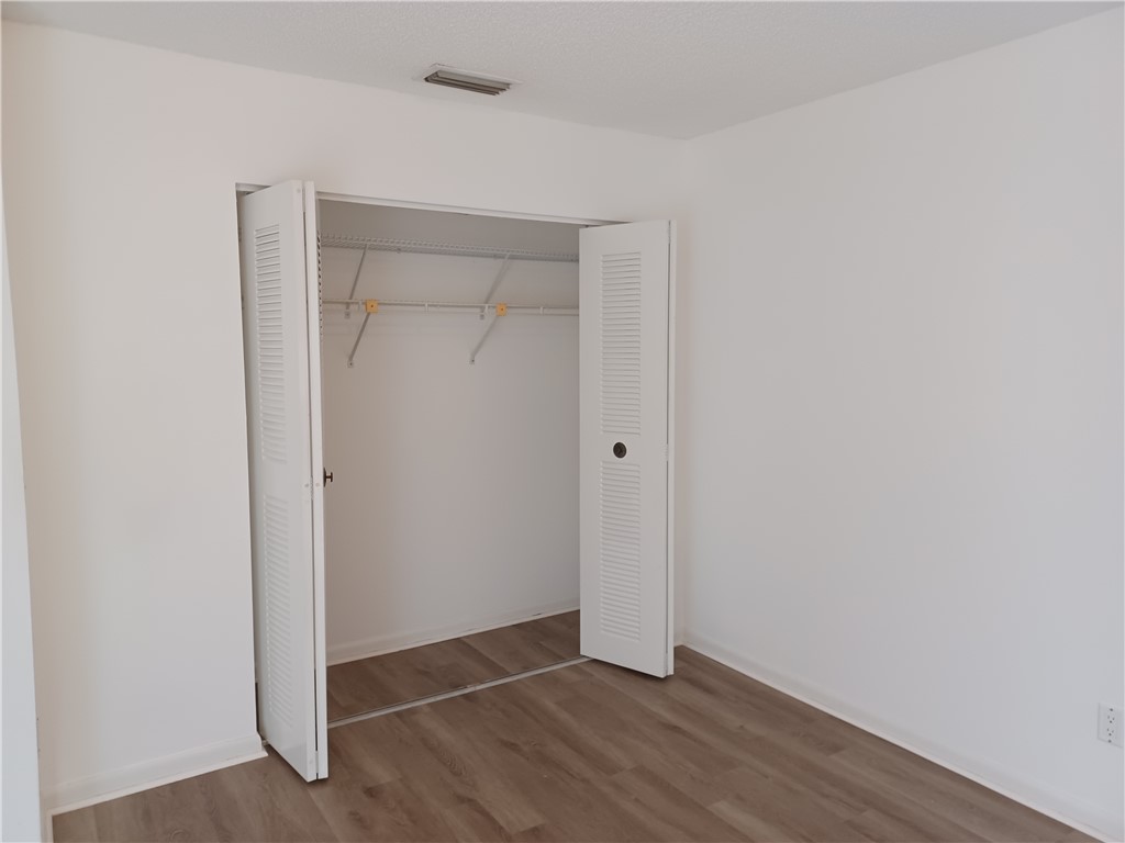 Undisclosed Address Vero Beach, FL 32960 - Photo 14 of 18 a view of an empty room with wooden floor